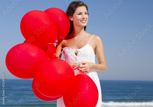 Photo: Beautiful girl holding red ballons Beautiful girl holding red ballons