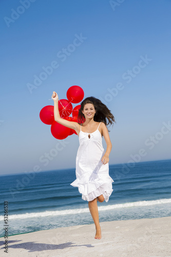 Photo: Beautiful girl running with red ballons Beautiful girl running with red ballons