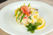 Small portion of food on big plate close up