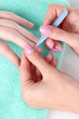 Man doing manicure in salon