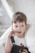 Photo: boy drinking cough syrup boy drinking cough syrup