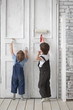 Photo: two children paint indoors two children paint indoors