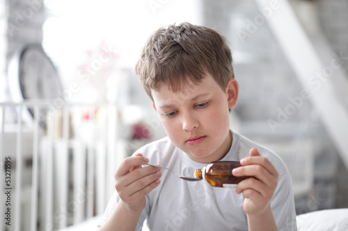 Photo: boy drinking cough syrup boy drinking cough syrup