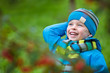 Adorable little boy having fun in autumn park