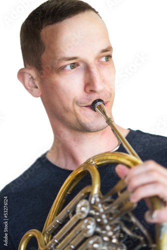 Photo: Caucasian male musician playing horn isolated on white Caucasian male musician playing horn isolated on white