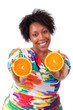 Photo: Overweight young black woman holding orange slices - African pe Overweight young black woman holding orange slices - African pe