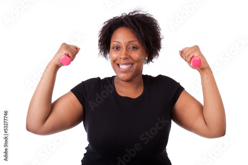 Photo: Portrait of a black fatty woman working out with free weights - Portrait of a black fatty woman working out with free weights -