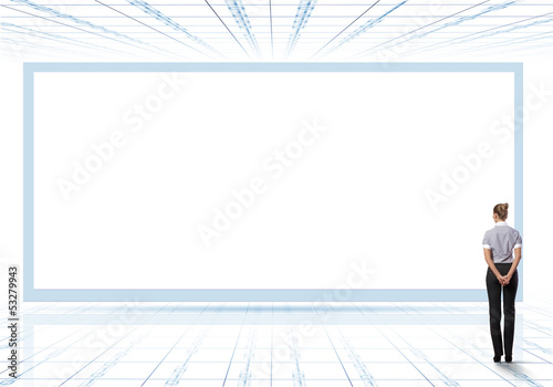 Photo: Business person standing near a blank billboard Business person standing near a blank billboard