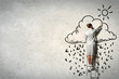 Woman standing on ladder drawing on wall