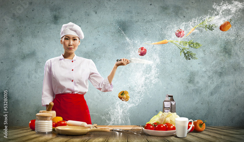Photo: Asian female cook with knife Asian female cook with knife
