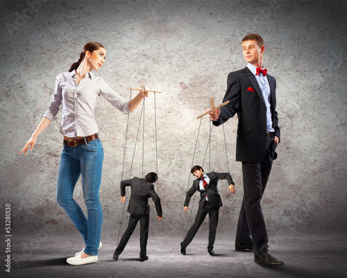 Photo: Businesspeople with marionettes Businesspeople with marionettes