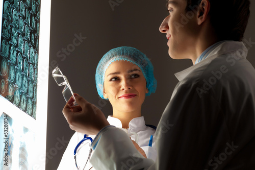 Photo: Two doctors examining x-ray results Two doctors examining x-ray results