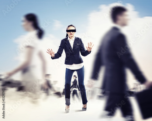 Photo: Businesswoman in blindfold among group of people Businesswoman in blindfold among group of people