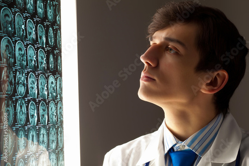 Photo: Man doctor looking at x-ray Man doctor looking at x-ray