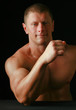 Healthy muscular young man. Isolated on black background