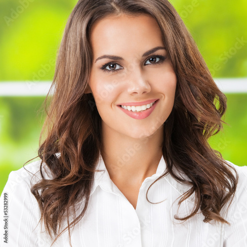 Photo: Young smiling cheerful businesswoman at office Young smiling cheerful businesswoman at office