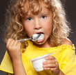 Little girl eating yogurt