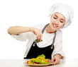 Portrait of a young cook in uniform preparing meal