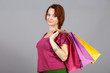 Girl with three papper bags in studio at gray background