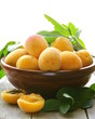 yellow sweet ripe apricots (peaches) with green leaves