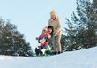 Photo: Two women with child sliding on sleds Two women with child sliding on sleds