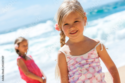 Photo: Portrait of cute girl on beach. Portrait of cute girl on beach.