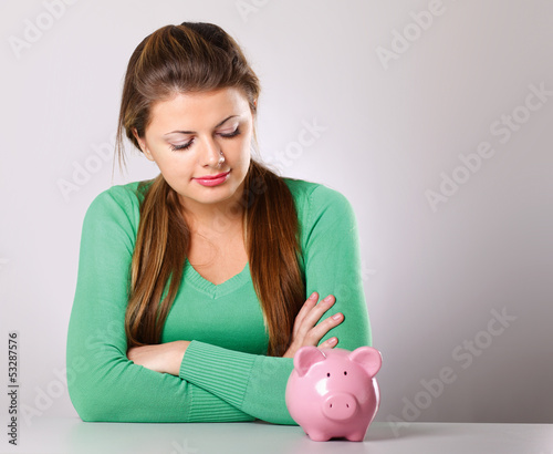 Photo: Young beautiful woman with piggy bank Young beautiful woman with piggy bank