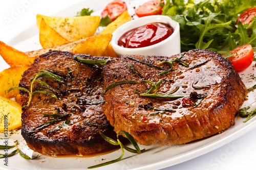 Photo: Grilled steak, baked potatoes and vegetables Grilled steak, baked potatoes and vegetables