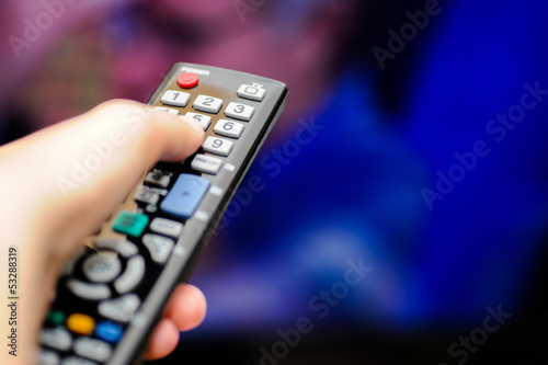 Photo: Mano col telecomando tv Mano col telecomando tv