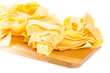 Fresh tagliatelle pasta nests on board isolated on white