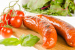 Grilled sausages with side salad and tomatoes isolated on white