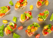 Photo: Cherry tomatoes and snow peas crostini on baking tray Cherry tomatoes and snow peas crostini on baking tray
