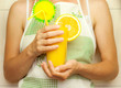 Woman holding a glass of orange juice