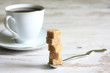 Cup of coffee with sugar on retro planks background concept