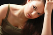 Depressed woman sitting, isolated on black background