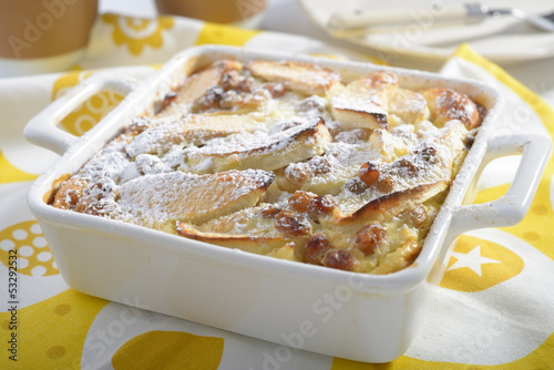 Photo: Apple flognarde with raisins and powdered sugar in a baking dish Apple flognarde with raisins and powdered sugar in a baking dish