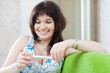 Smiling woman measuring temperature