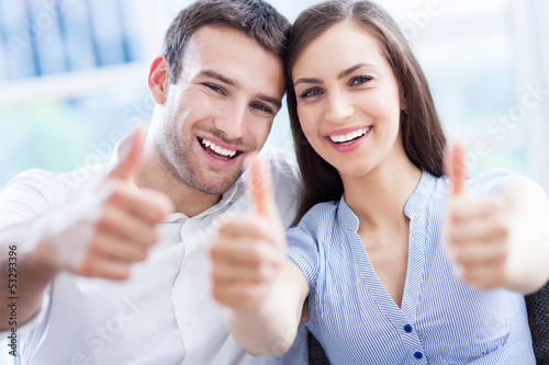 Photo: Young couple with thumbs up Young couple with thumbs up