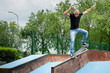 Skateboarder doing a skateboard trick at skatepark.