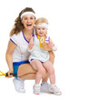 Portrait of mother and baby in tennis clothes holding medal