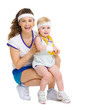Portrait of mother and baby in tennis clothes with medal