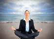 Business woman doing yoga on the beach.