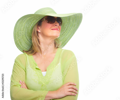 Photo: Woman wearing sunglasses and a hat. Woman wearing sunglasses and a hat.