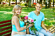 Pregnant woman with man outdoor.