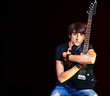 Photo: Man playing guitar. Man playing guitar.