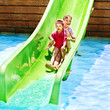 Child on water slide at aquapark.