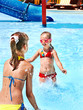 Children on water slide at aquapark.