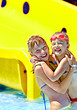 Child on water slide at aquapark.