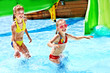 Children on water slide at aquapark.