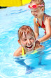 Child on water slide at aquapark.